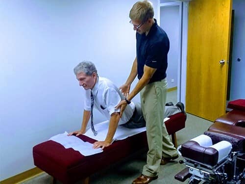 Image of instruction on prone press up exercise with chiropractor wheaton